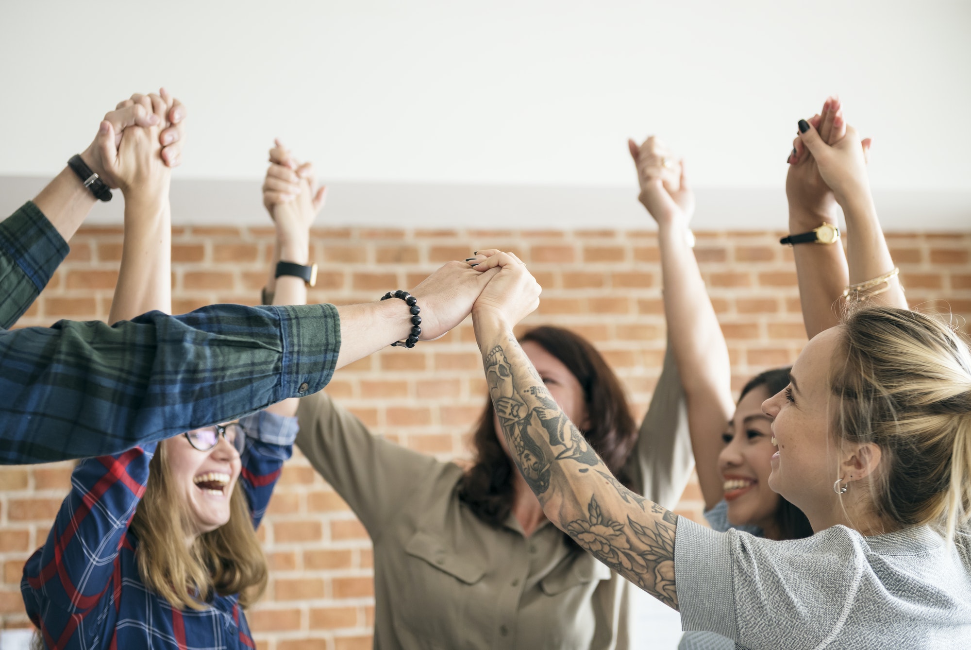 business team raising their hands up to celebrate